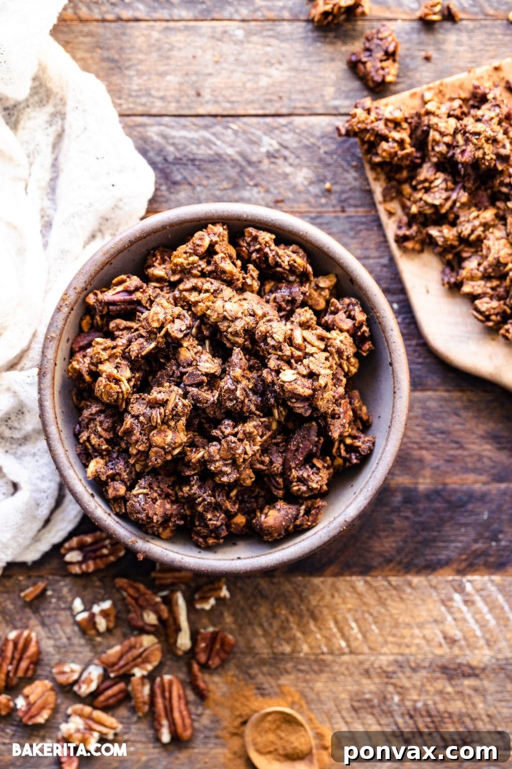 A beautifully packaged jar of vegan gingerbread cookie granola, tied with a ribbon, perfect for gifting.