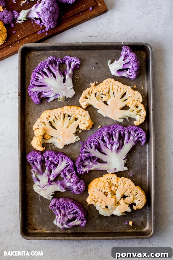 A close-up of a single Vegan Tahini Cauliflower Steak on a cutting board, ready for roasting.