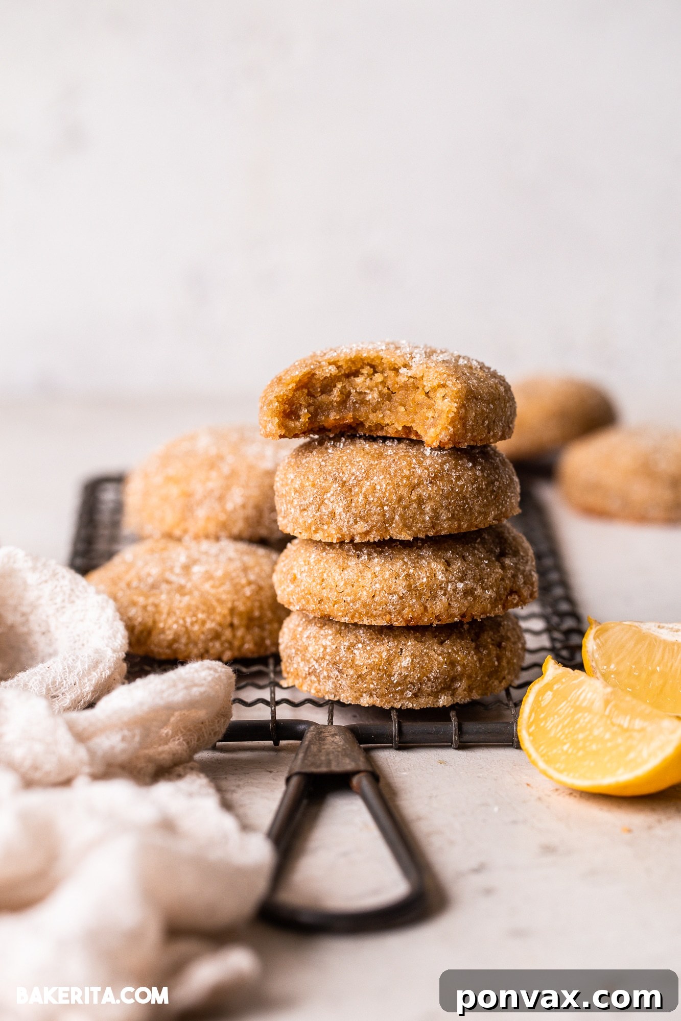 Zesty Soft Chewy Vegan Lemon Cookies 3 Close-up of a stack of Vegan Gluten-Free Lemon Cookies, showing their soft texture and golden-brown edges with a fine sugary coating.