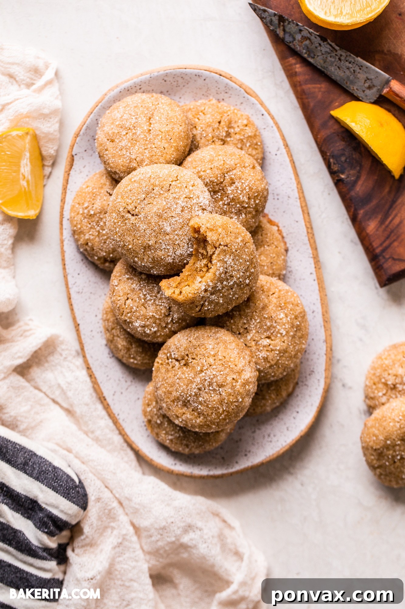 Zesty Soft Chewy Vegan Lemon Cookies 6 Close-up of a freshly baked Vegan Gluten-Free Lemon Cookie, showing its crinkled top and sugary coating, ready to be enjoyed.