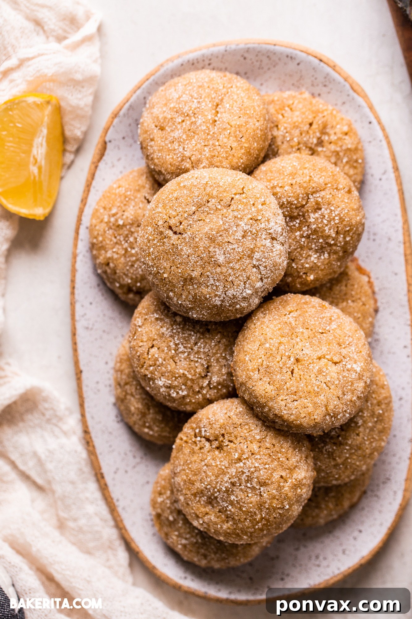 Zesty Soft Chewy Vegan Lemon Cookies 7 A plate of freshly baked Vegan Gluten-Free Lemon Cookies with a glass of milk, suggesting a delightful serving.