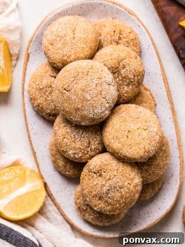 A stack of golden Vegan Gluten-Free Lemon Cookies, ready to eat.
