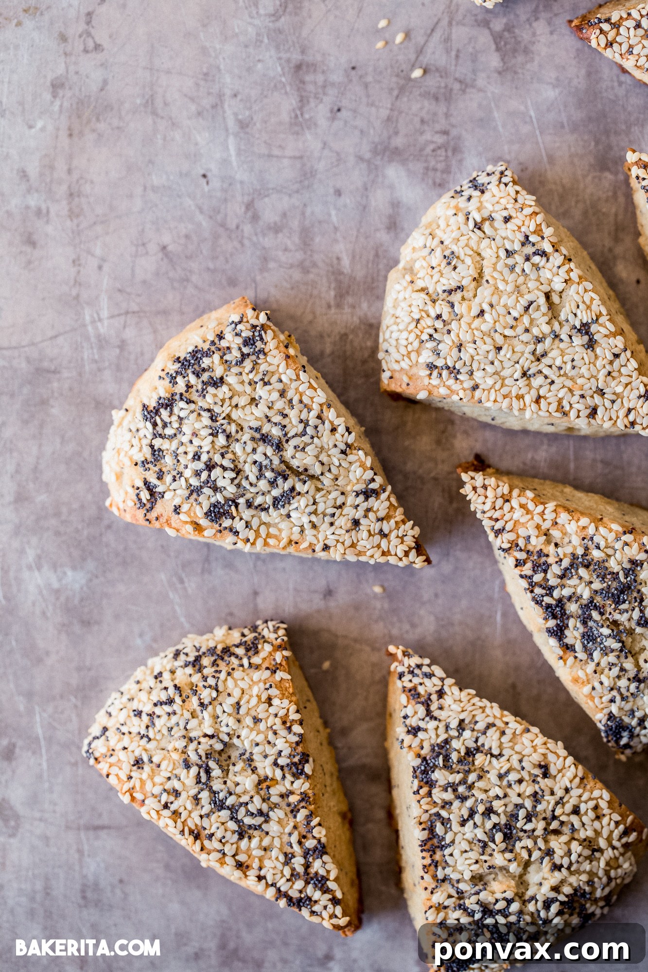 Delicious golden-brown Gluten-Free Sourdough Scones with 'Everything Bagel' seasoning on top, ready to be served on a rustic wooden board.