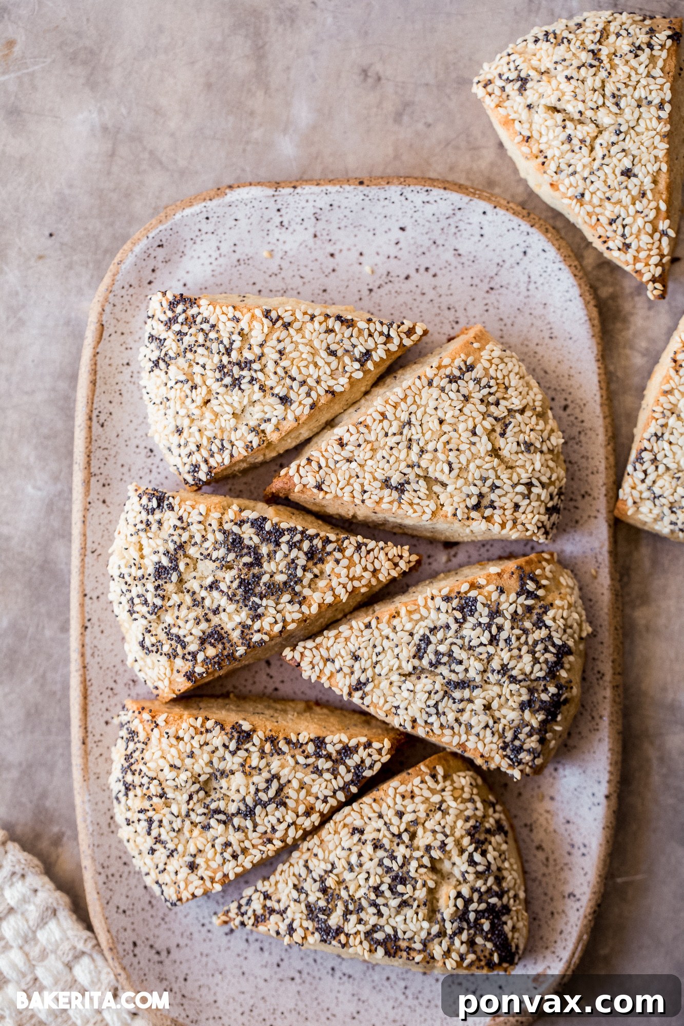 Two Gluten-Free Sourdough Scones, elegantly cut in half and spread with a creamy vegan butter, ready for a delightful savory snack.
