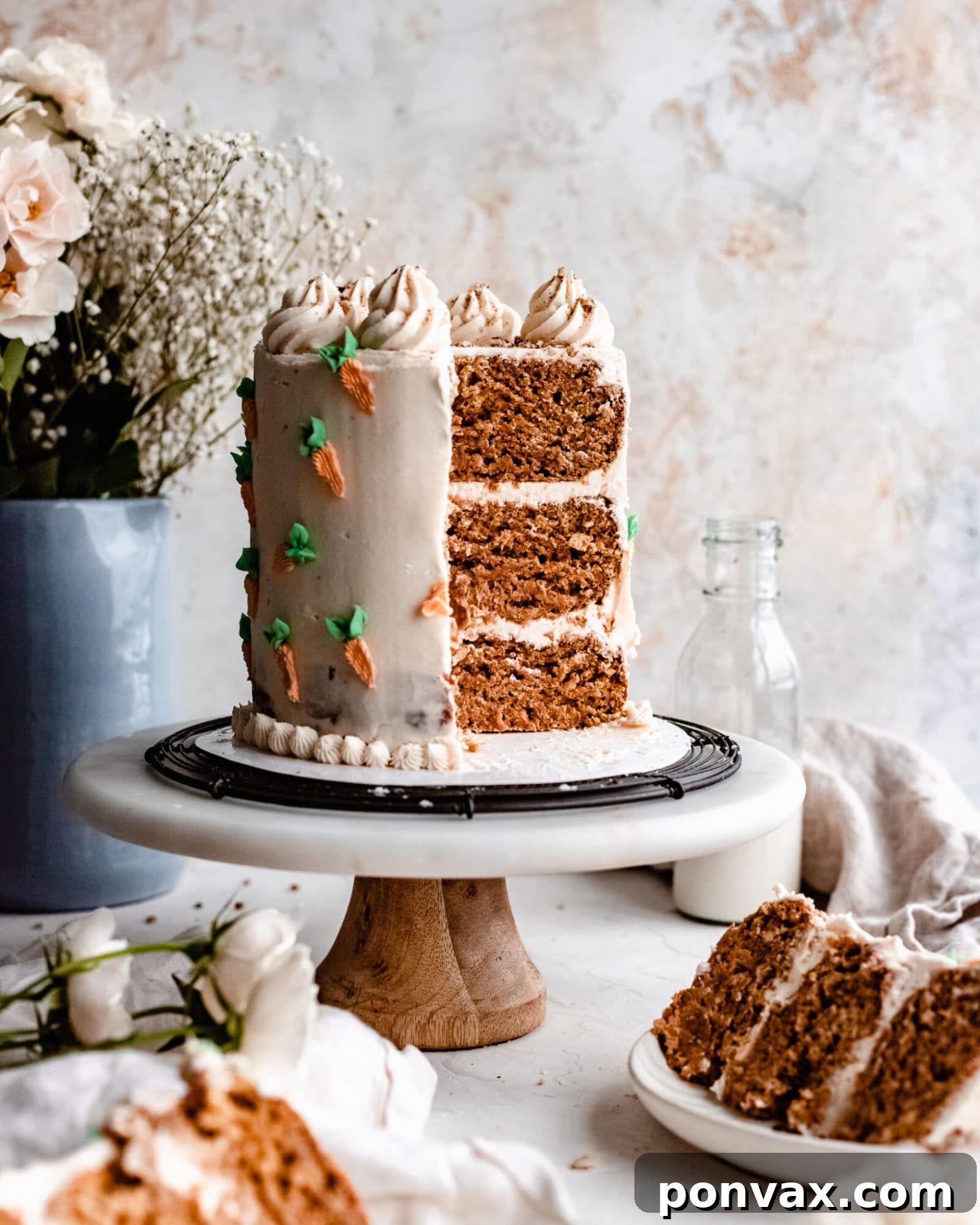 Layered gluten-free vegan carrot cake with homemade cream cheese frosting by The Banana Diaries.