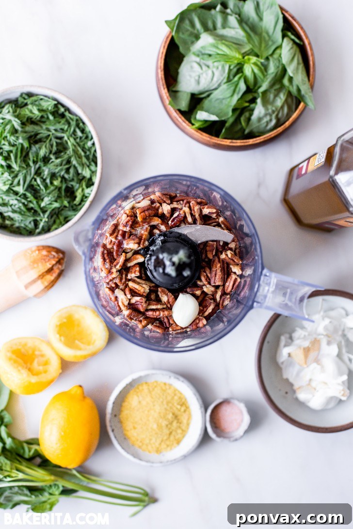 Zero-Waste Vegan Carrot Green Pesto 5 Close-up of fresh carrot greens being added to a food processor, with other pesto ingredients visible.