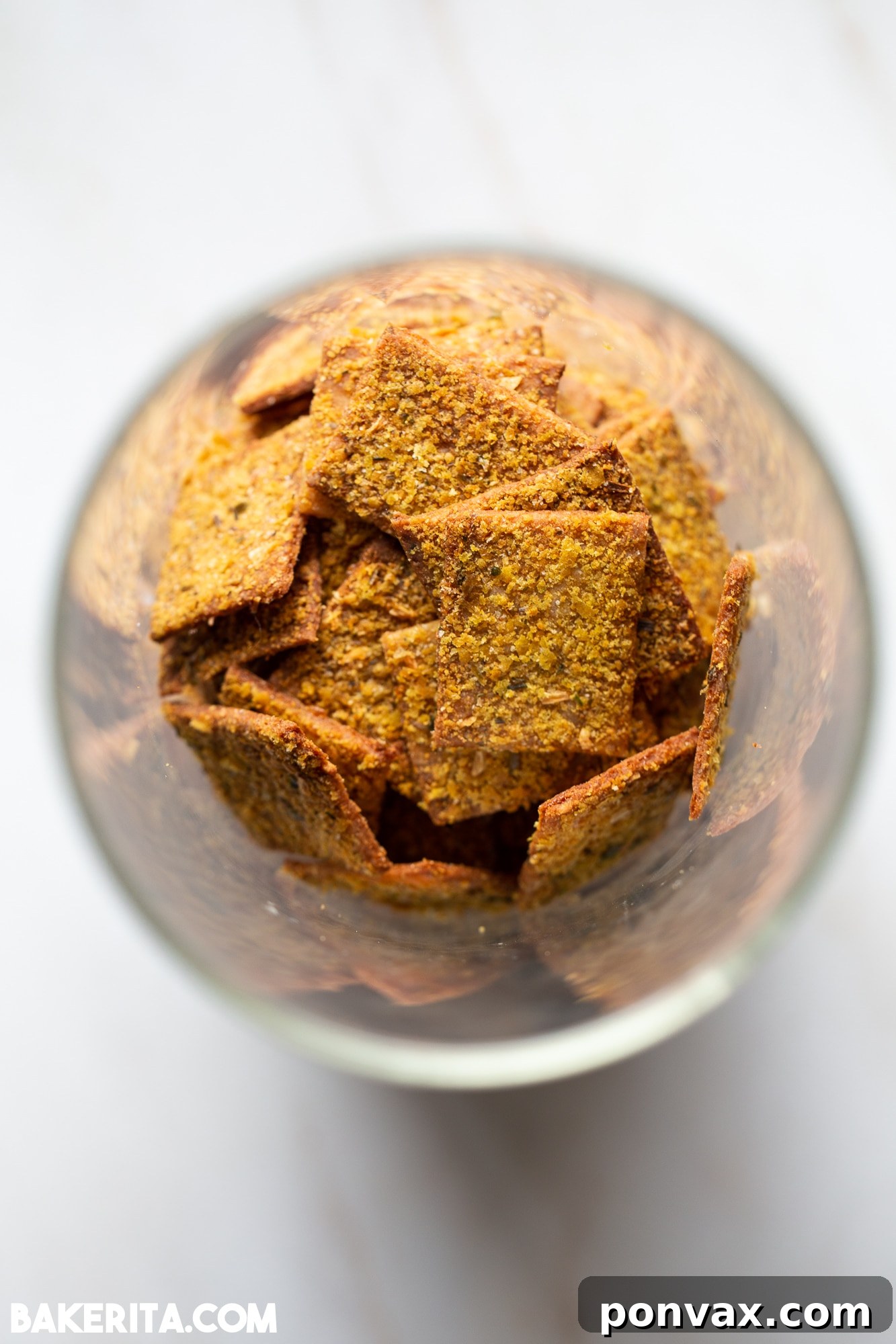 Artisan Gluten-Free Sourdough Crisps 3 A close-up of savory gluten-free sourdough crackers seasoned with herbs and seeds.