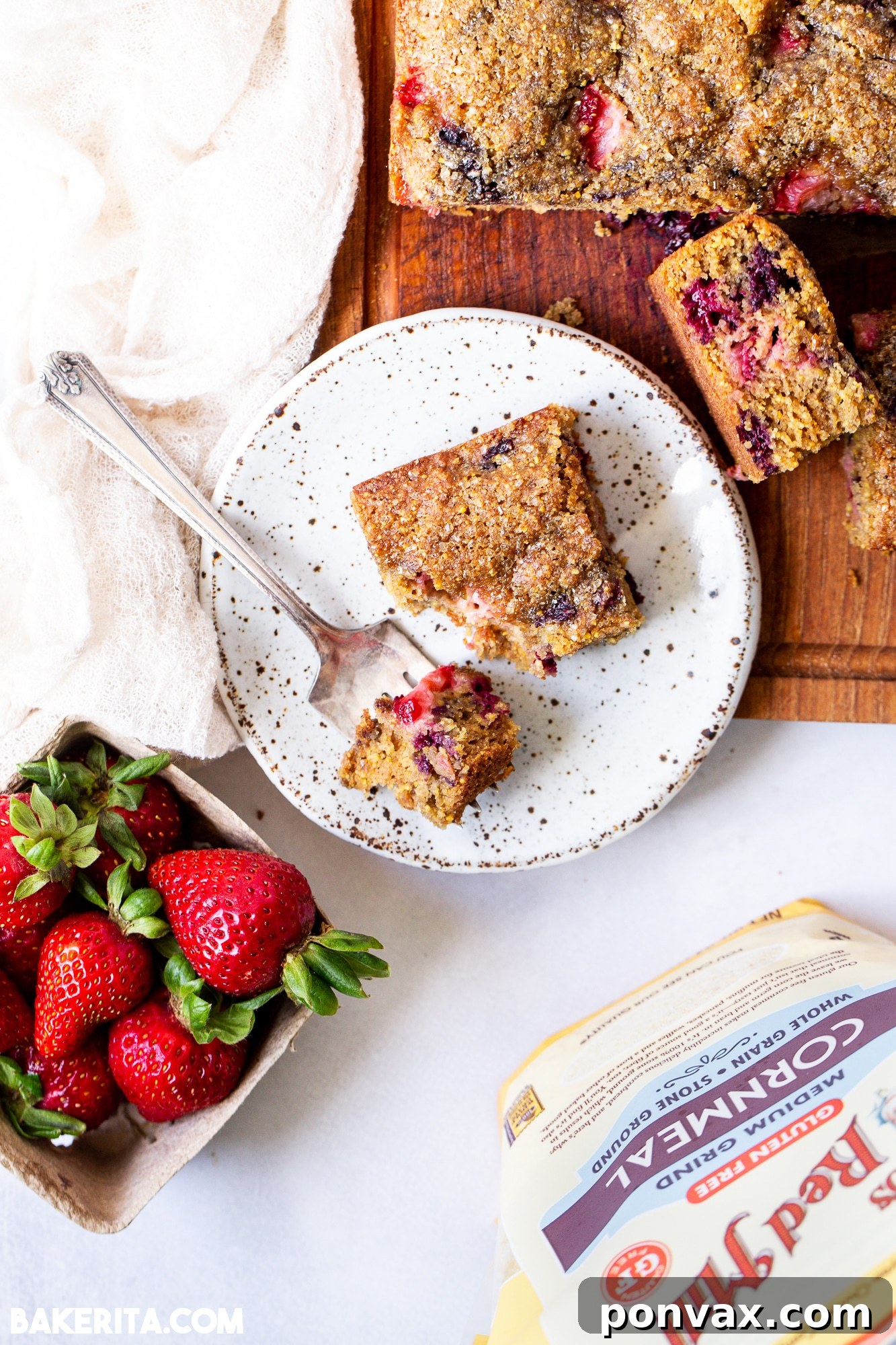 Another view of the Berry Cornmeal Cake, showcasing its fluffy texture and berry distribution.
