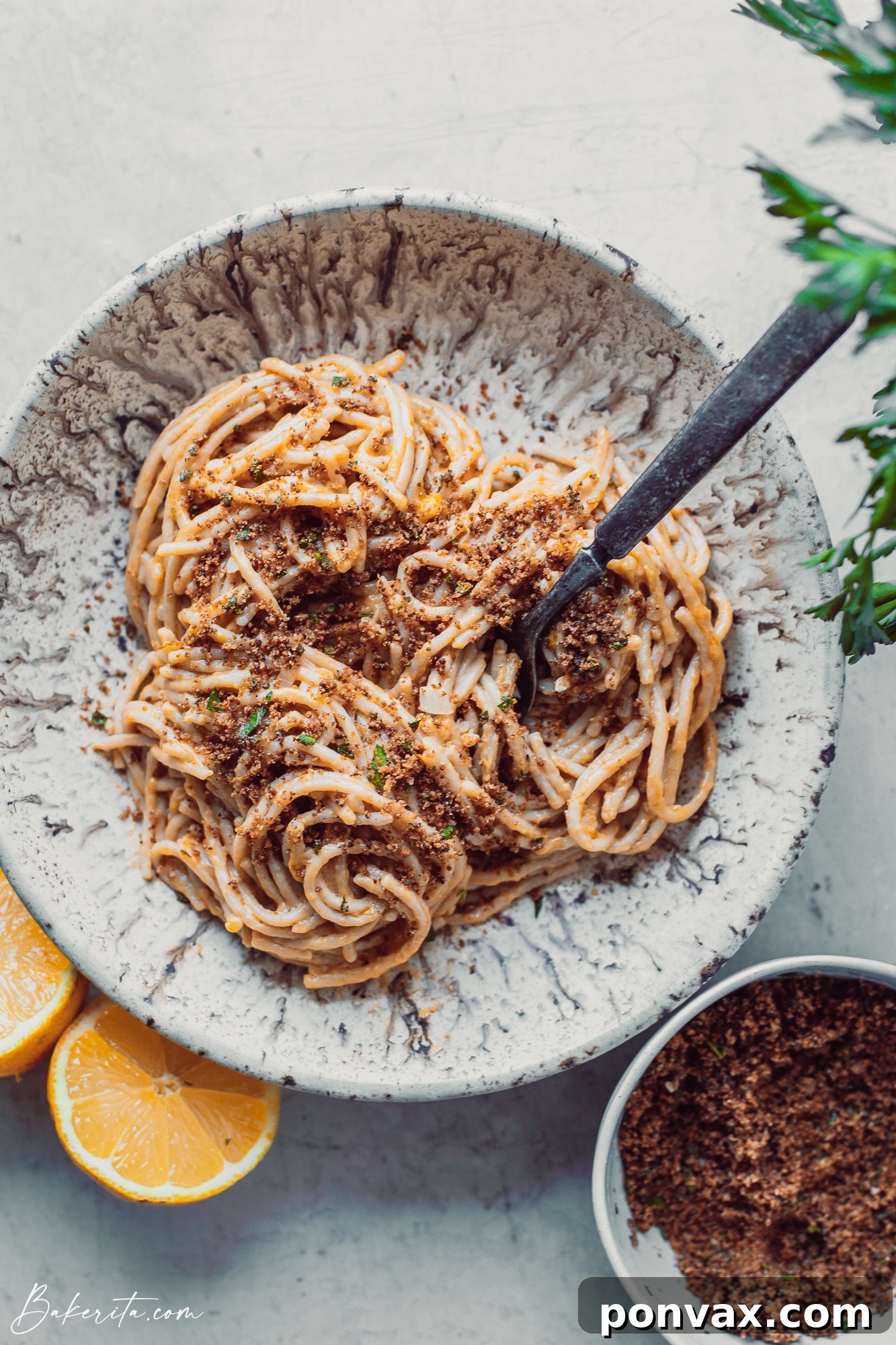 A close-up shot of a steaming bowl of One-Pot Creamy Lemon Pasta garnished with fresh parsley and toasted breadcrumbs.