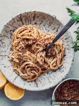 One-Pot Creamy Lemon Pasta in a bowl, garnished with herbs and a slice of lemon.
