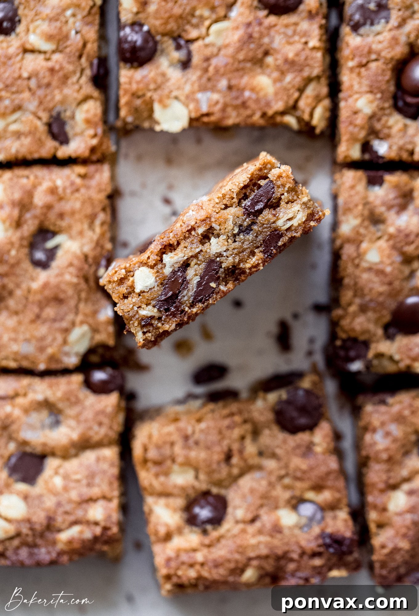 Decadent Plant-Based Oat Chocolate Squares 5 Freshly baked Vegan Gluten-Free Oatmeal Chocolate Chip Bars cooling on a wire rack.