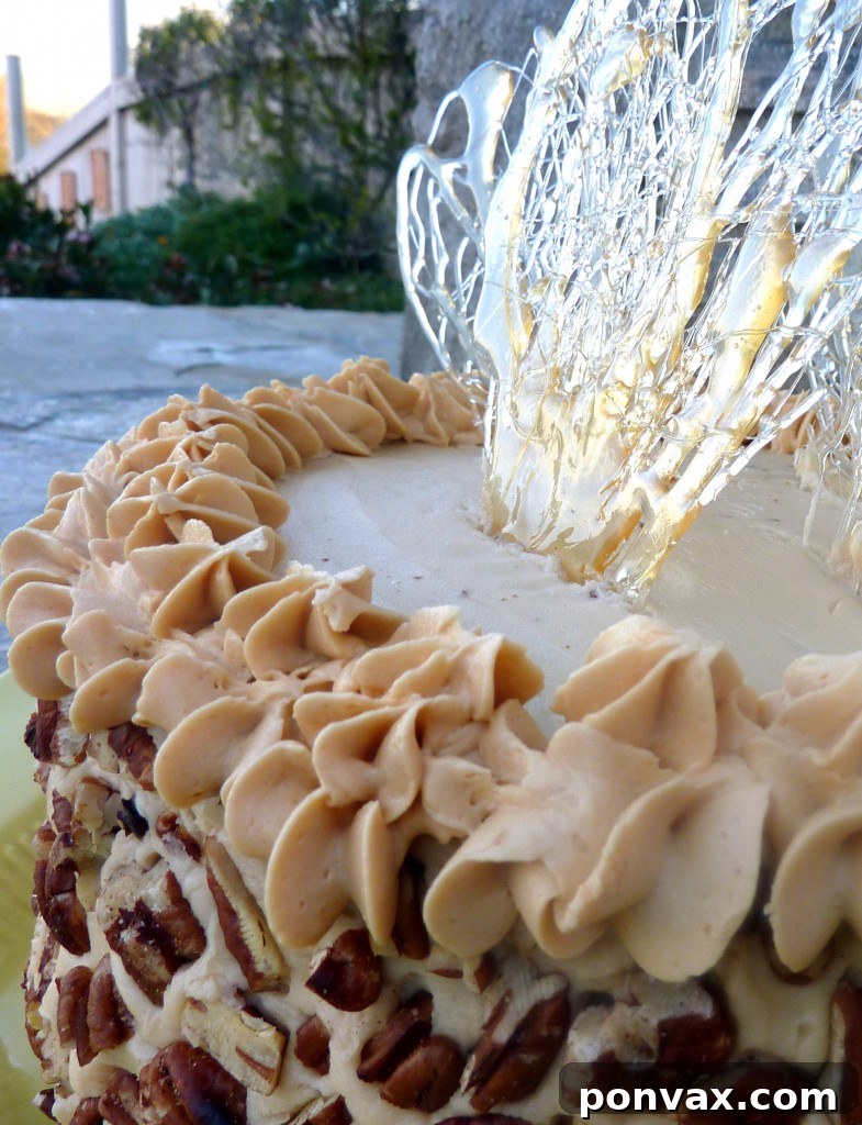 Close-up of a slice of Apple Spice Layer Cake showcasing its moist texture and rich caramel buttercream
