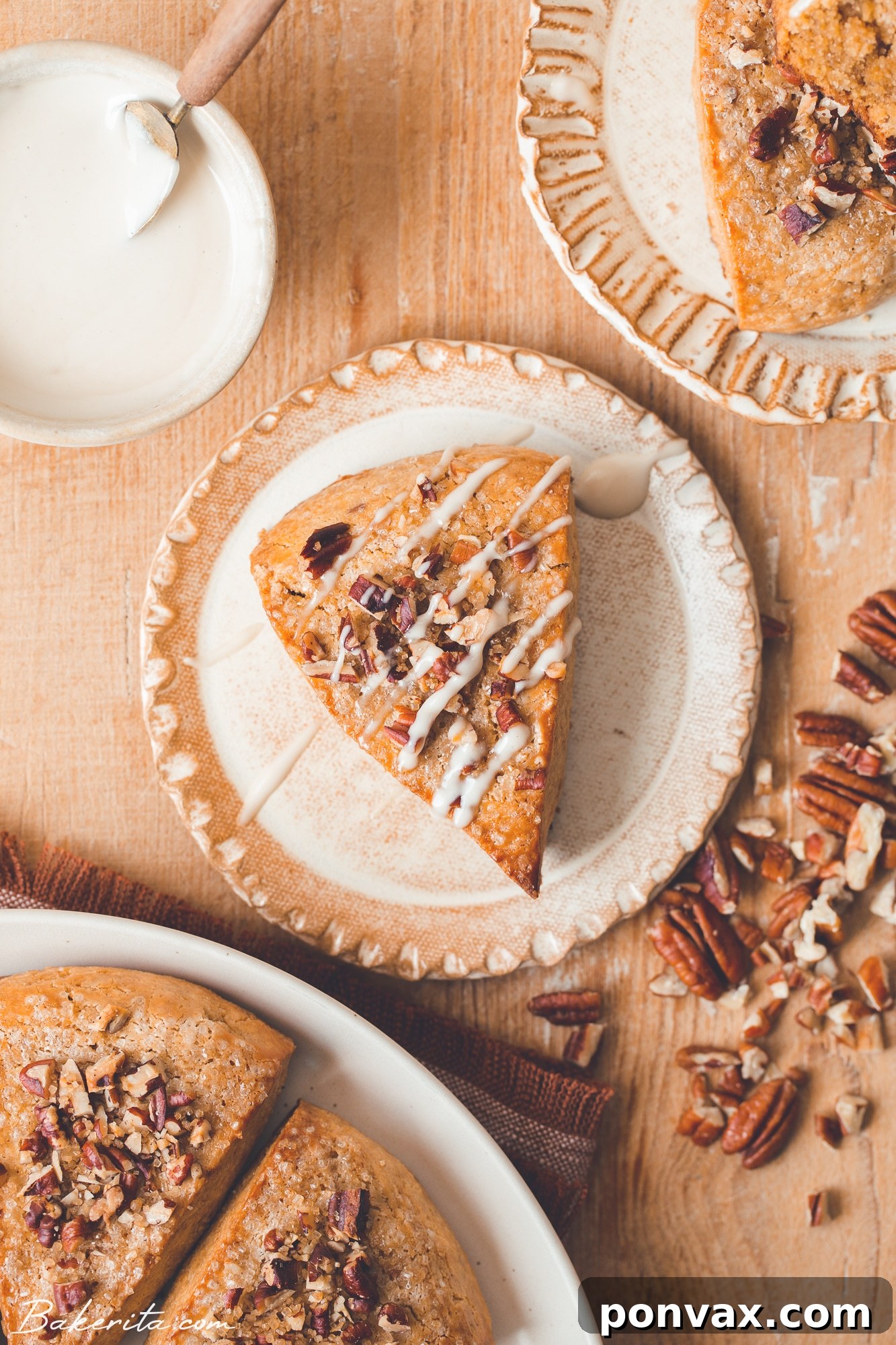 Close-up of a perfectly baked Gluten-Free Vegan Pumpkin Scone topped with a light maple glaze and crushed pecans, ready to be enjoyed.