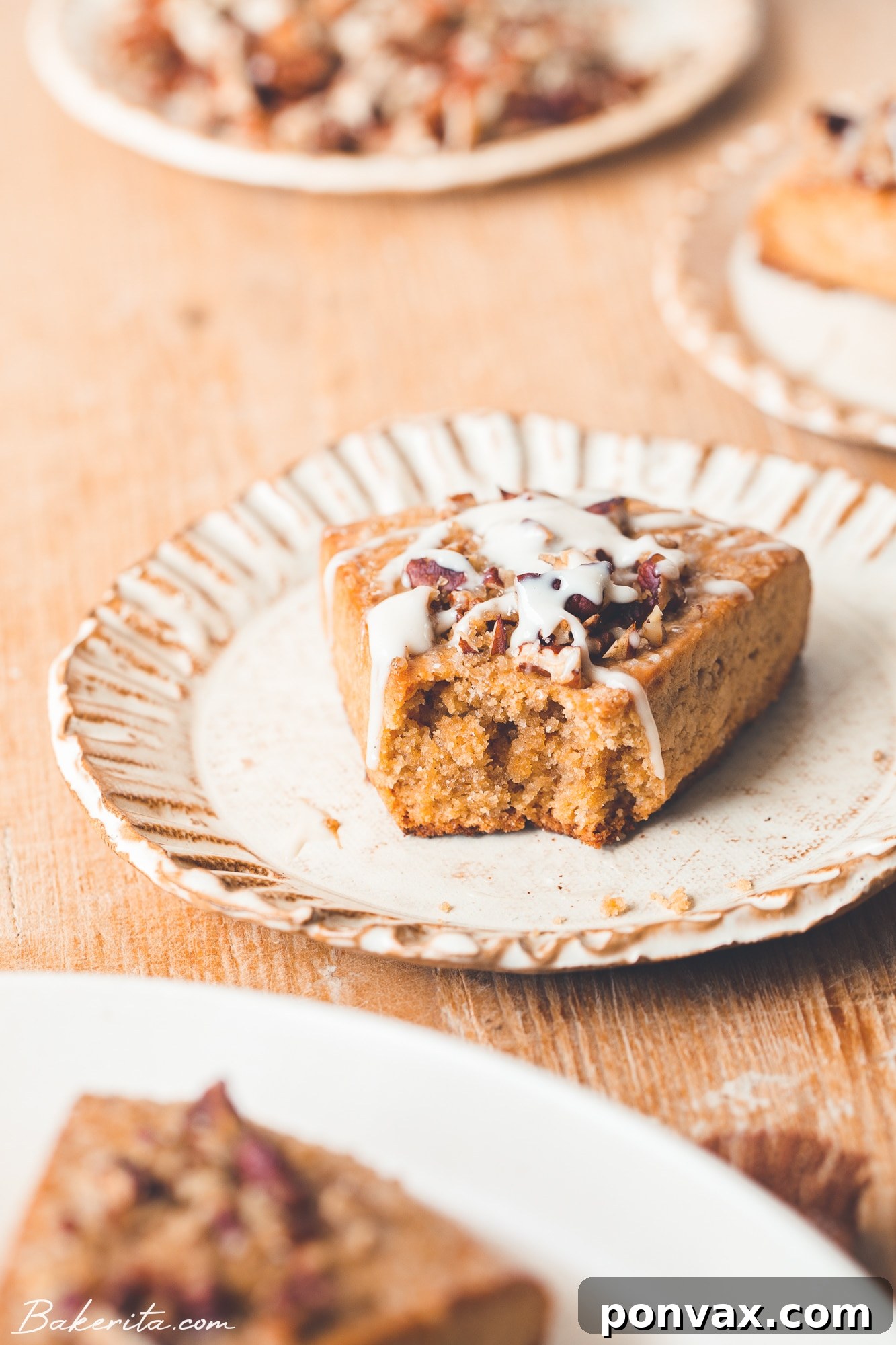 Freshly baked Gluten-Free Vegan Pumpkin Scones cooling on a wire rack, with some drizzled with maple glaze.