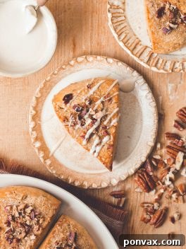 A beautifully presented Gluten-Free Vegan Pumpkin Scone with maple glaze and pecans.