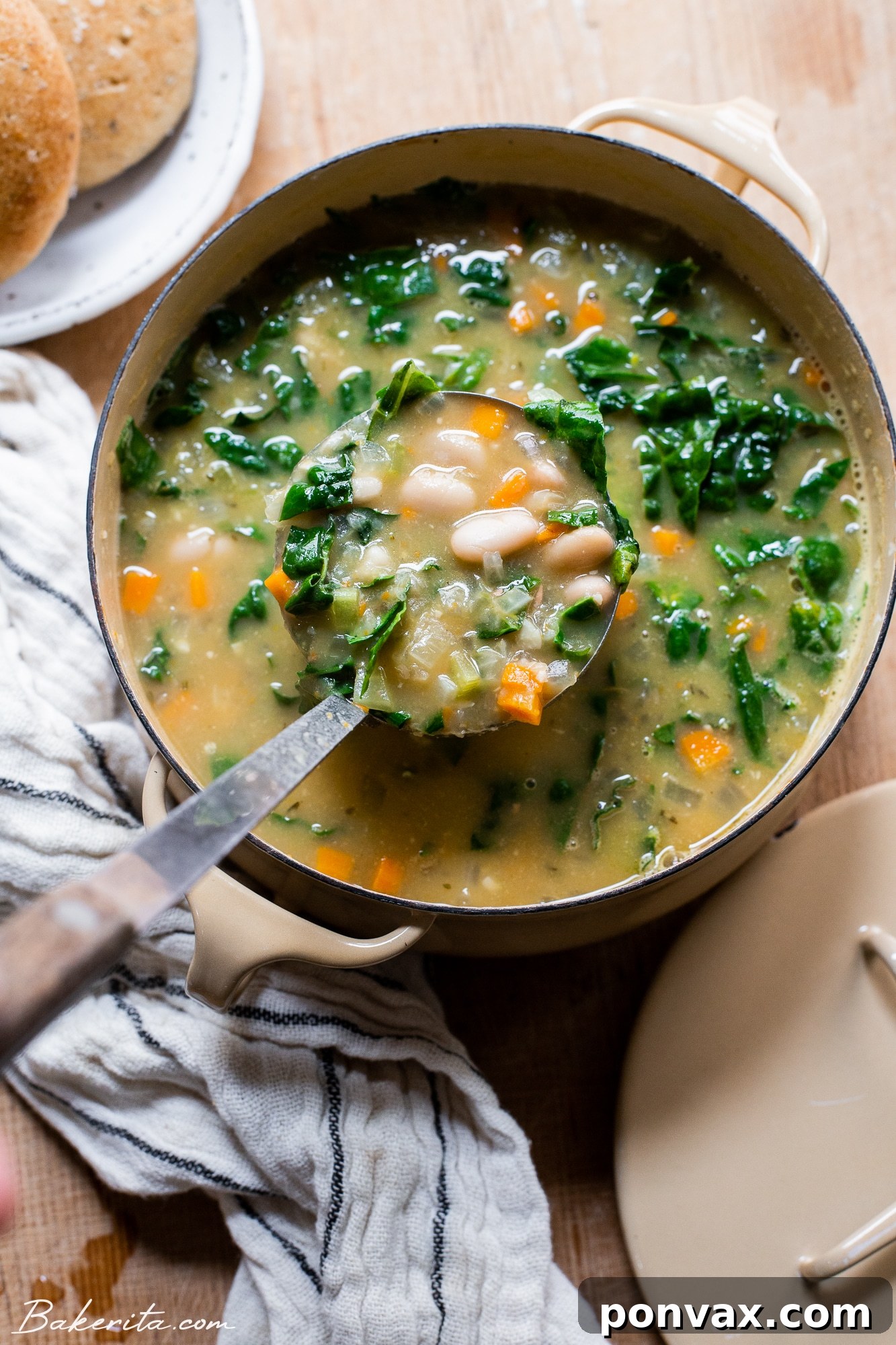 Hearty Vegan Kale and White Bean Soup 4 Overhead shot of creamy vegan kale and white bean soup in a bowl.