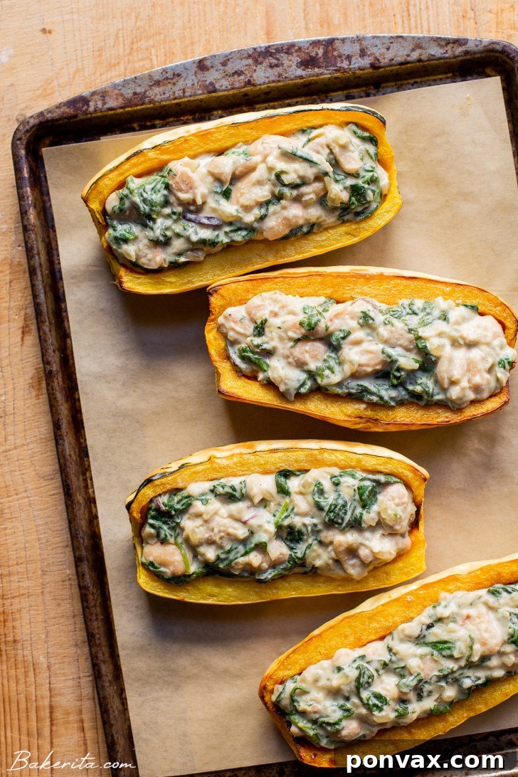A roasted delicata squash half, golden brown and perfectly tender, ready to be filled.