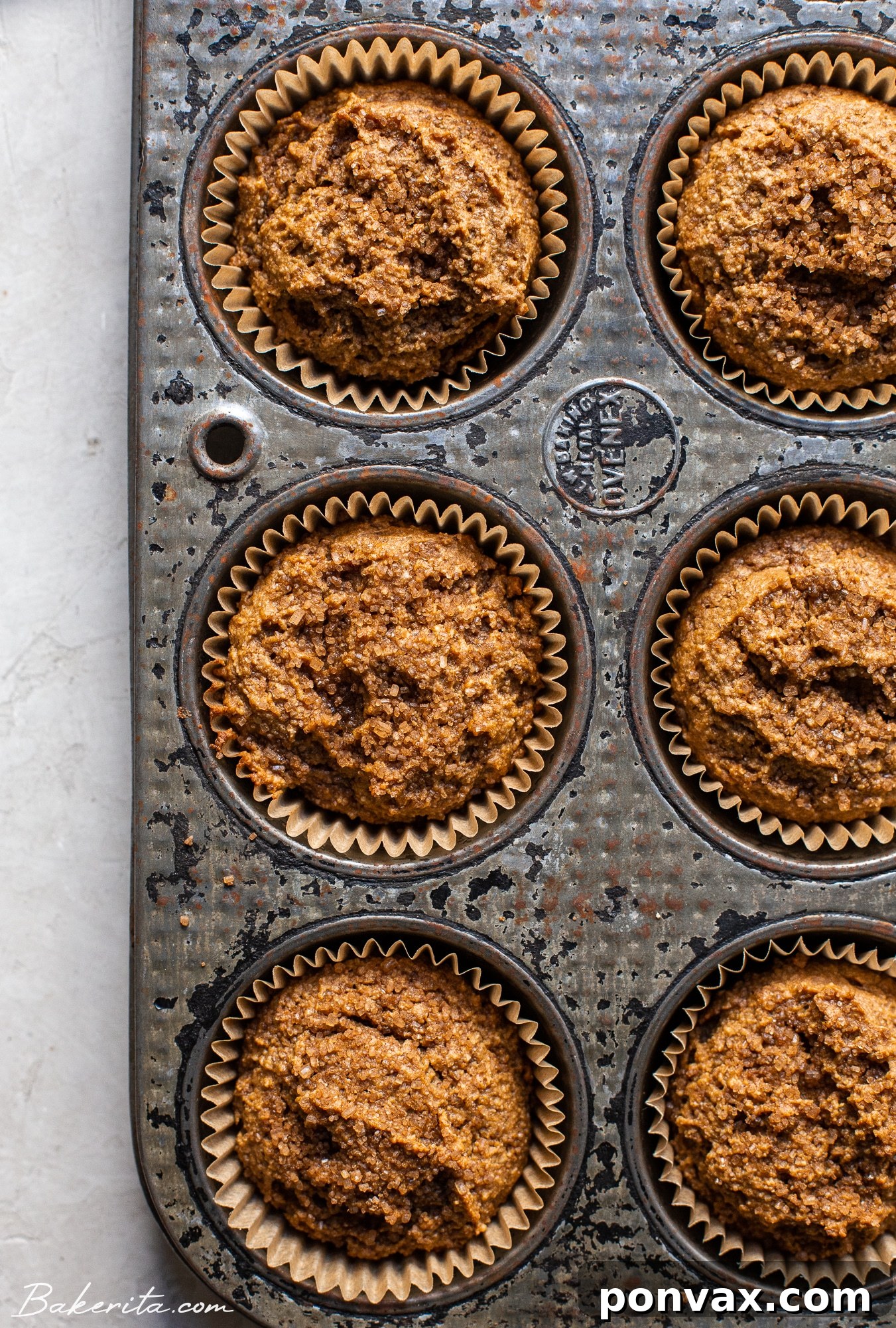 Several Gluten-Free Vegan Chai Muffins are arranged on a white platter, showing their fluffy texture and glaze.