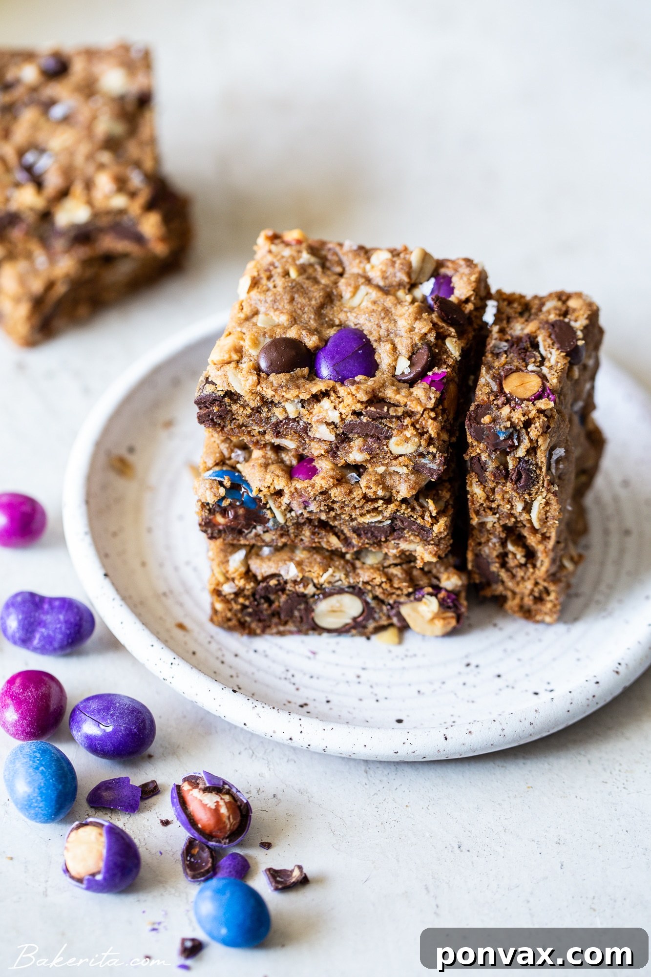 Fully Loaded Vegan Cookie Bars 5 Close-up of a single Vegan Monster Cookie Bar with a bite taken out, showing the soft interior