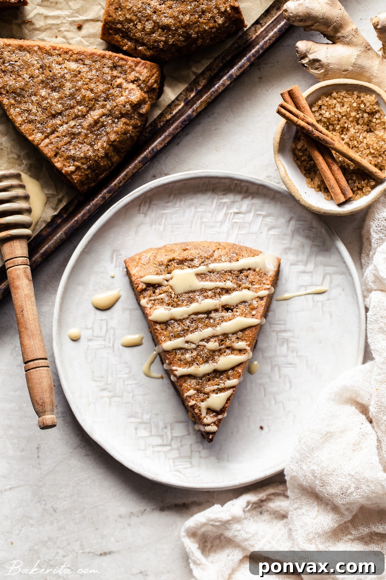 Close-up of a beautifully baked vegan gingerbread scone, showcasing its flaky texture and golden-brown crust.