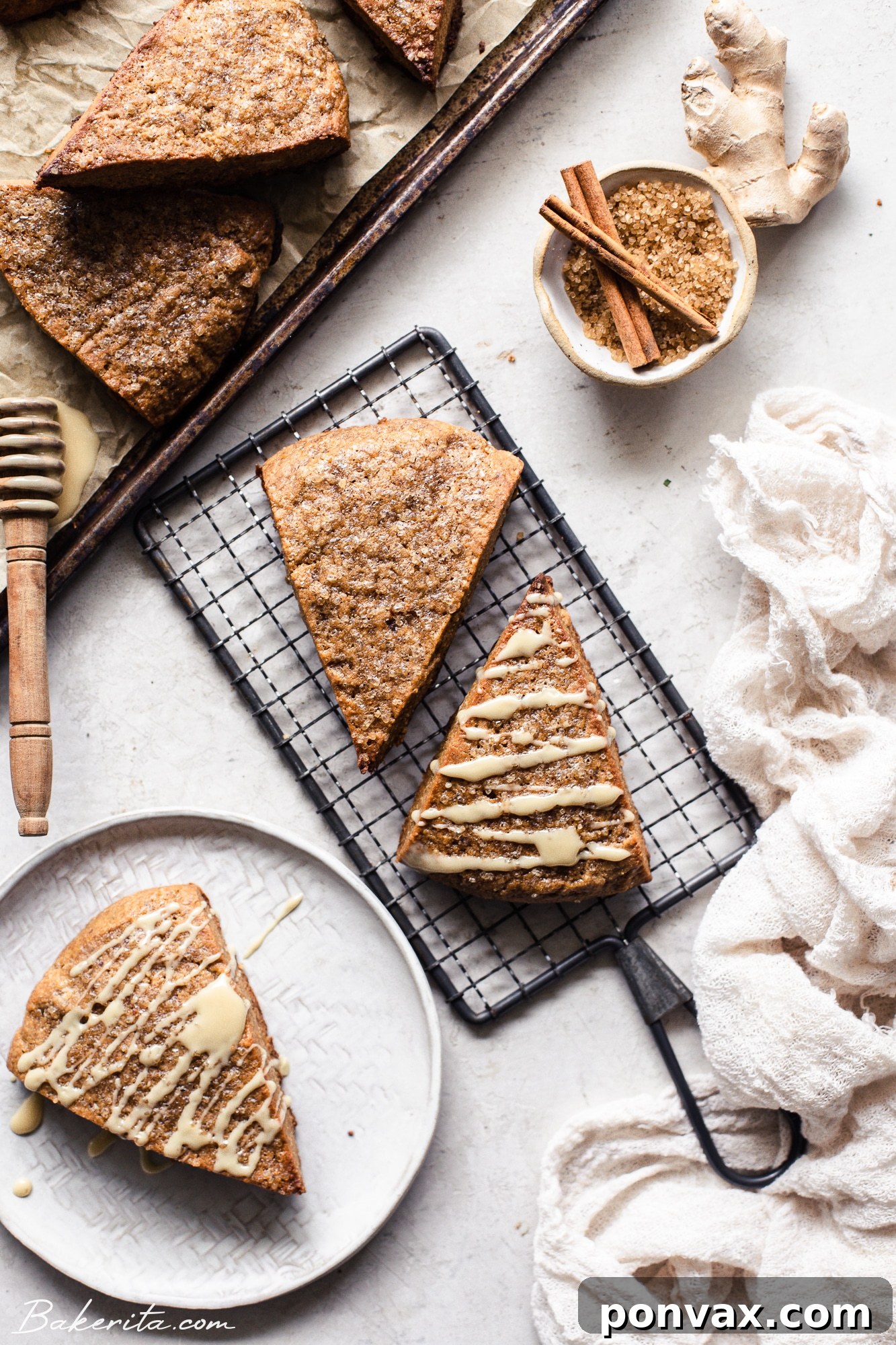 A stack of vegan gingerbread scones on a festive platter, garnished with cinnamon sticks and star anise, ready for serving.