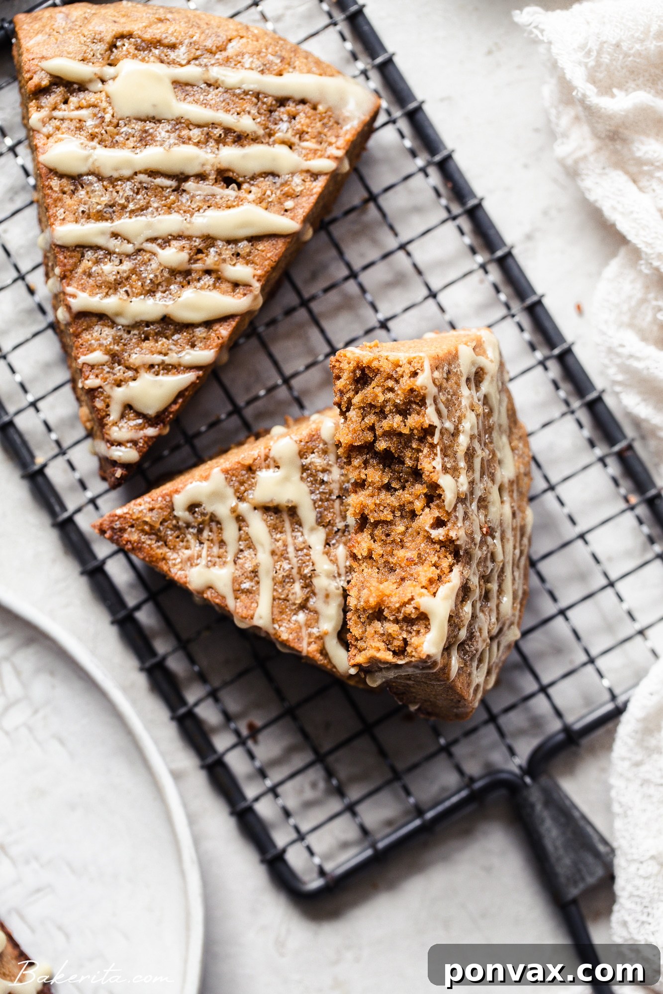 Overhead shot of vegan gingerbread scones, golden-brown and topped with turbinado sugar, cooling on a rack.