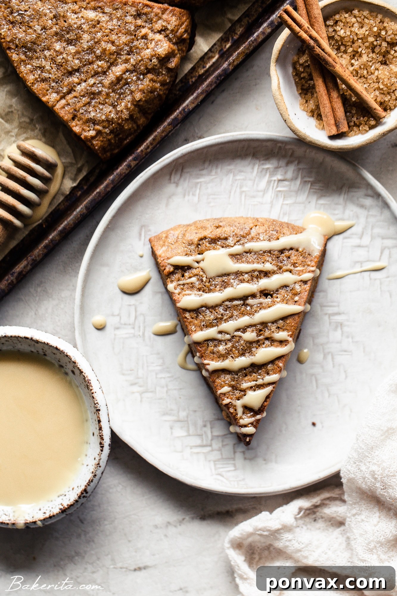 A festive table setting featuring vegan gingerbread scones, a cup of coffee, and holiday decorations, inviting a cozy experience.
