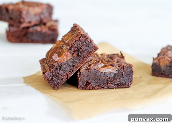 Stacked Salted Dulce De Leche Brownies with a visible rich chocolate texture and caramel