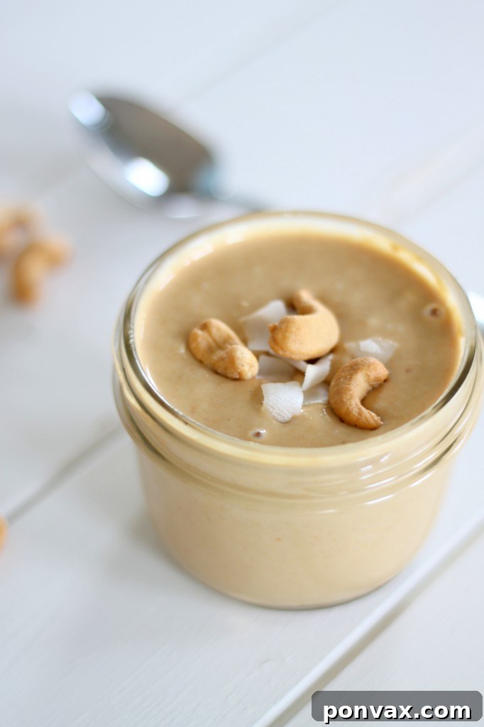 Close-up of smooth and creamy Coconut Cashew Butter in a glass jar.