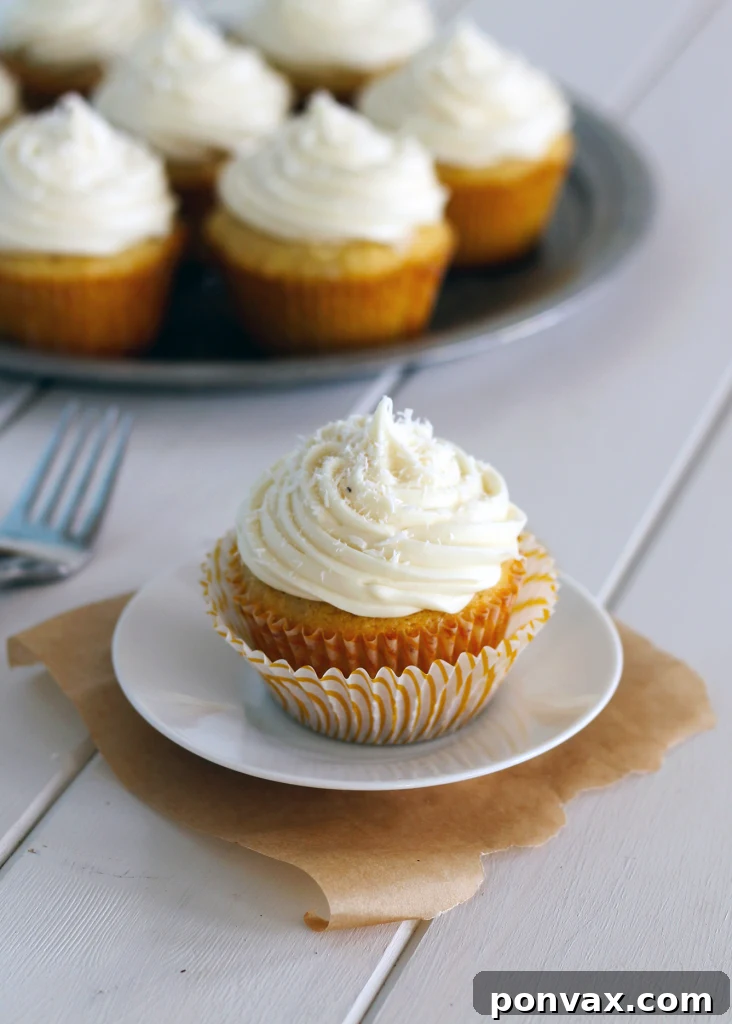 Soft and sweet Coconut Cupcakes with a hidden coconut truffle and creamy white chocolate cream cheese frosting