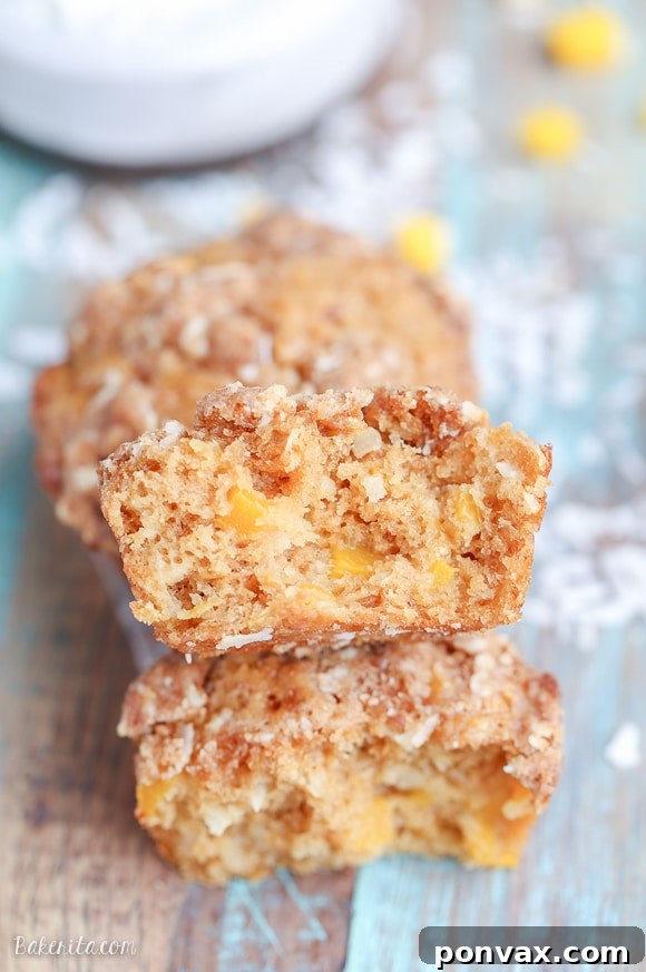 Tropical Mango Coconut Crumble Muffins 2 Freshly baked Mango Coconut Crumble Muffins on a cooling rack