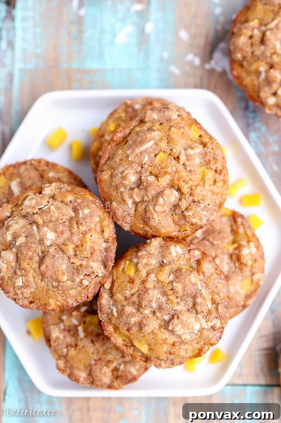 Tropical Mango Coconut Crumble Muffins 3 Close-up of a single Mango Coconut Crumble Muffin with a golden crumble topping