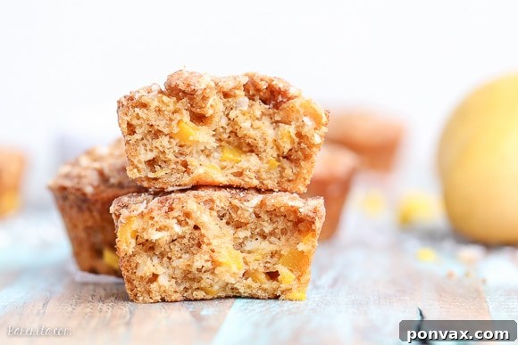 Tropical Mango Coconut Crumble Muffins 6 A sliced Mango Coconut Crumble Muffin showing the juicy mango chunks inside