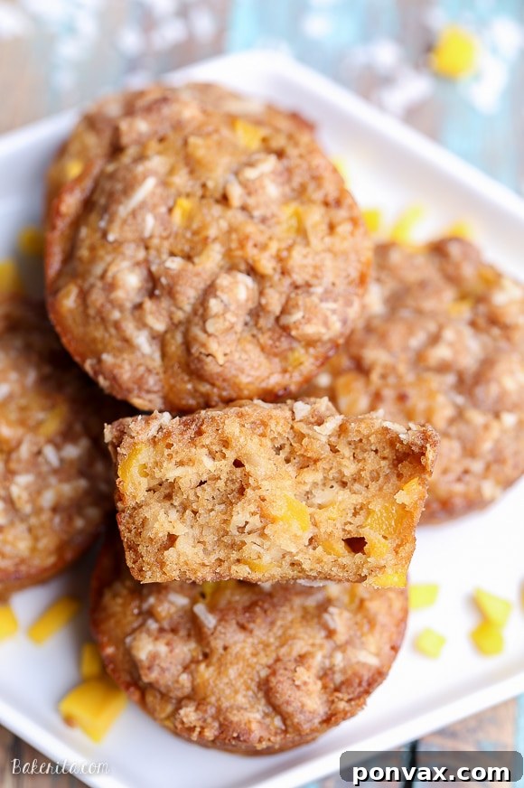 Tropical Mango Coconut Crumble Muffins 7 A stack of three Mango Coconut Crumble Muffins, ready to be eaten