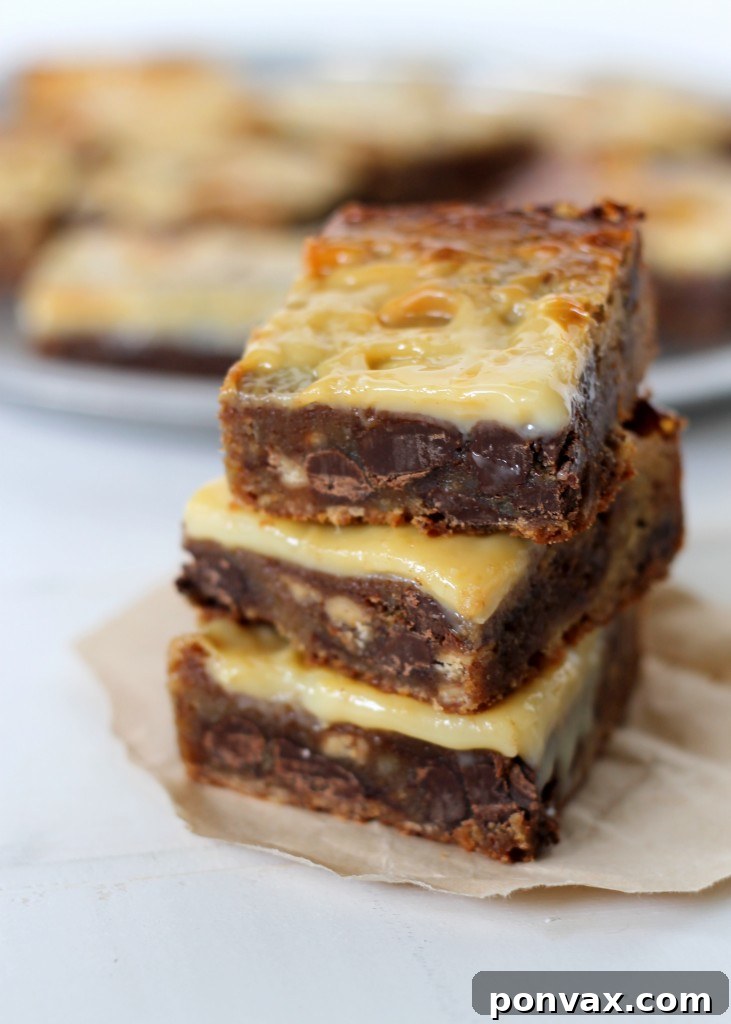 Delicious Gooey Chocolate Toffee Blondies, rich with brown sugar and topped with caramelized sweetened condensed milk.
