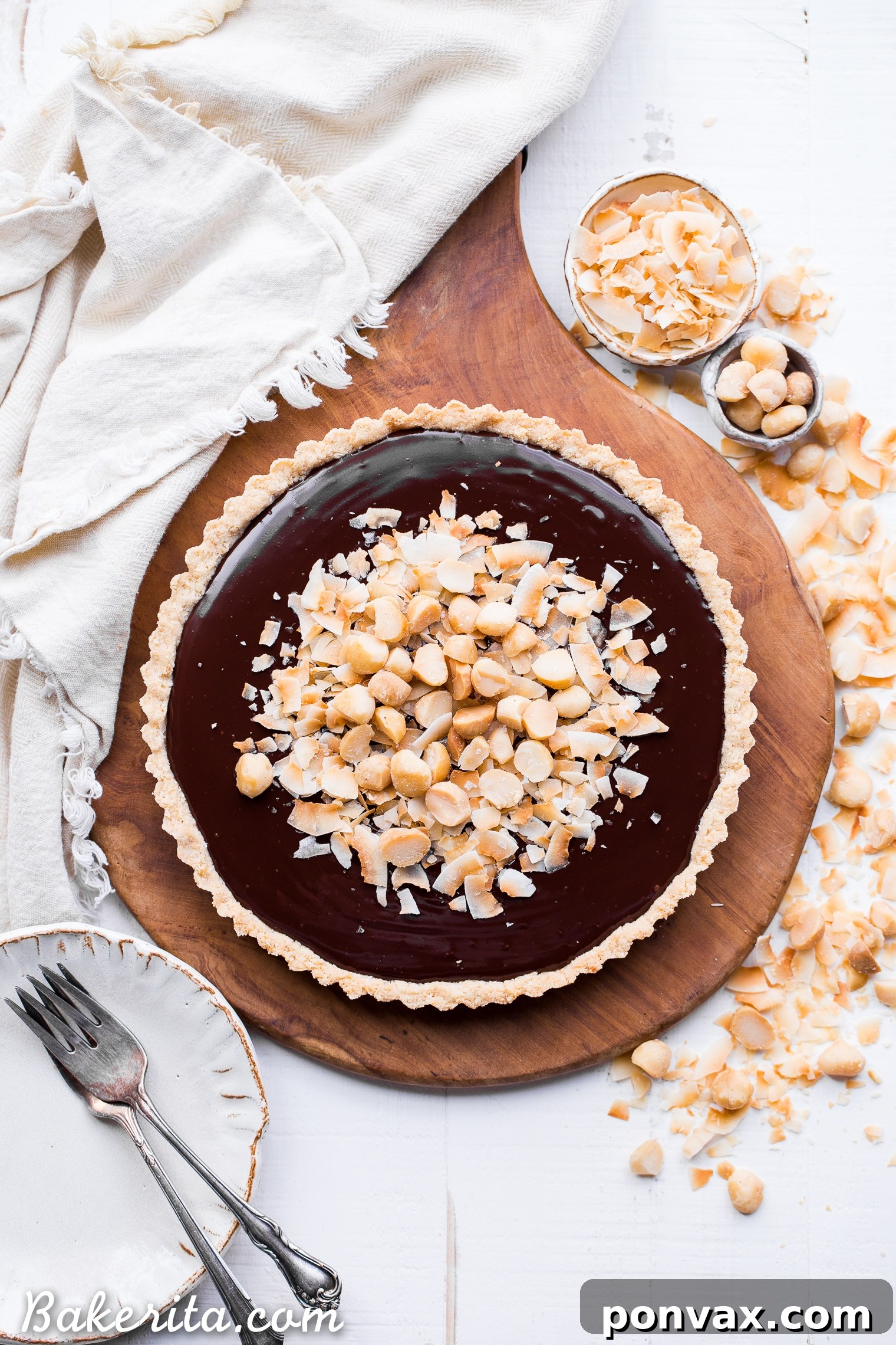 This Dark Chocolate, Coconut & Macadamia Nut Tart is decadent, delicious and easy to make. It has a coconut crust that's filled with a luscious chocolate ganache and topped with toasted coconut and macadamia nuts. You'd never guess that this nutty tart is gluten-free, vegan, Paleo, and refined sugar-free!