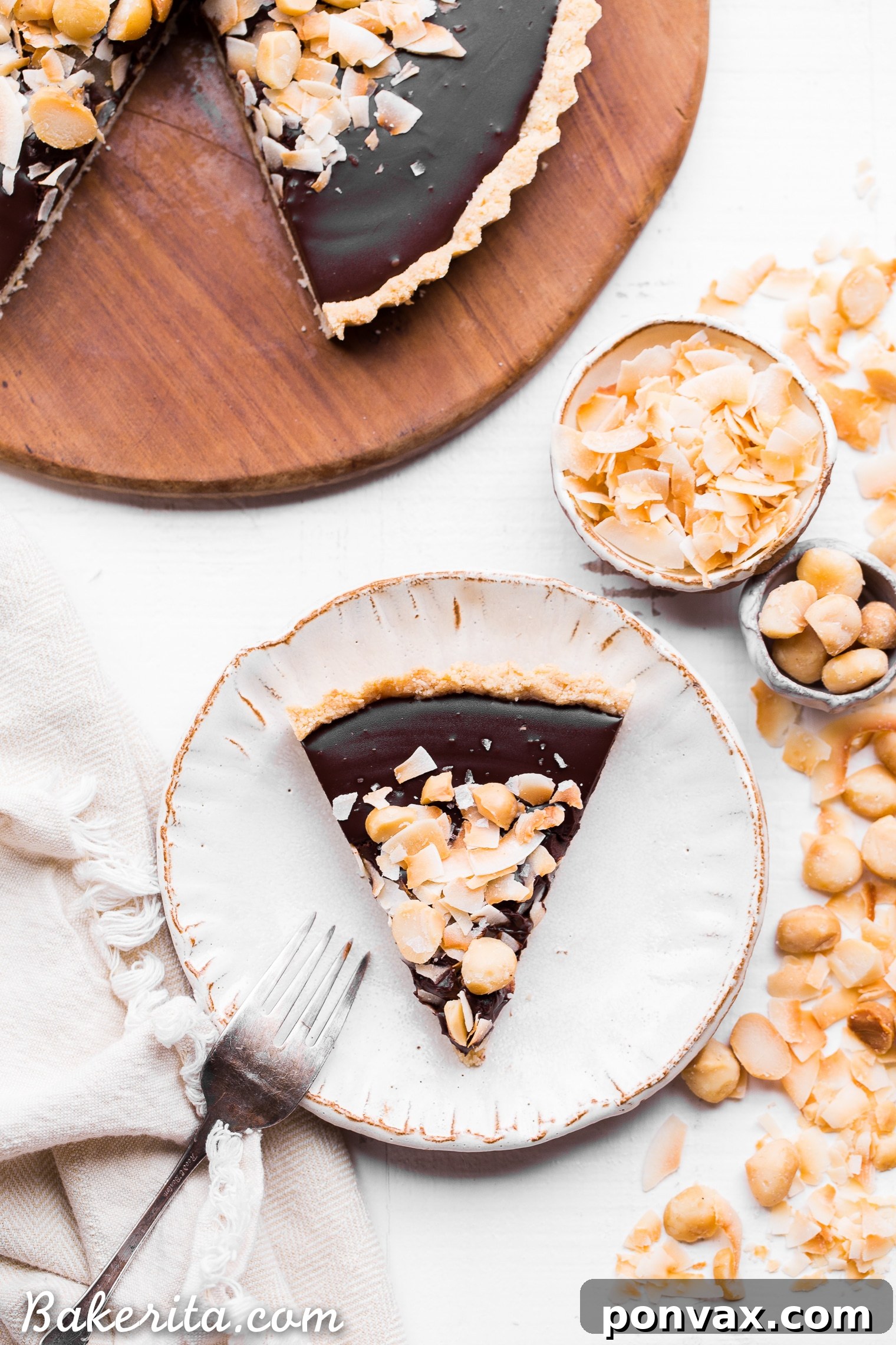 This Dark Chocolate, Coconut & Macadamia Nut Tart is decadent, delicious and easy to make. It has a coconut crust that's filled with a luscious chocolate ganache and topped with toasted coconut and macadamia nuts. You'd never guess that this nutty tart is gluten-free, vegan, Paleo, and refined sugar-free!