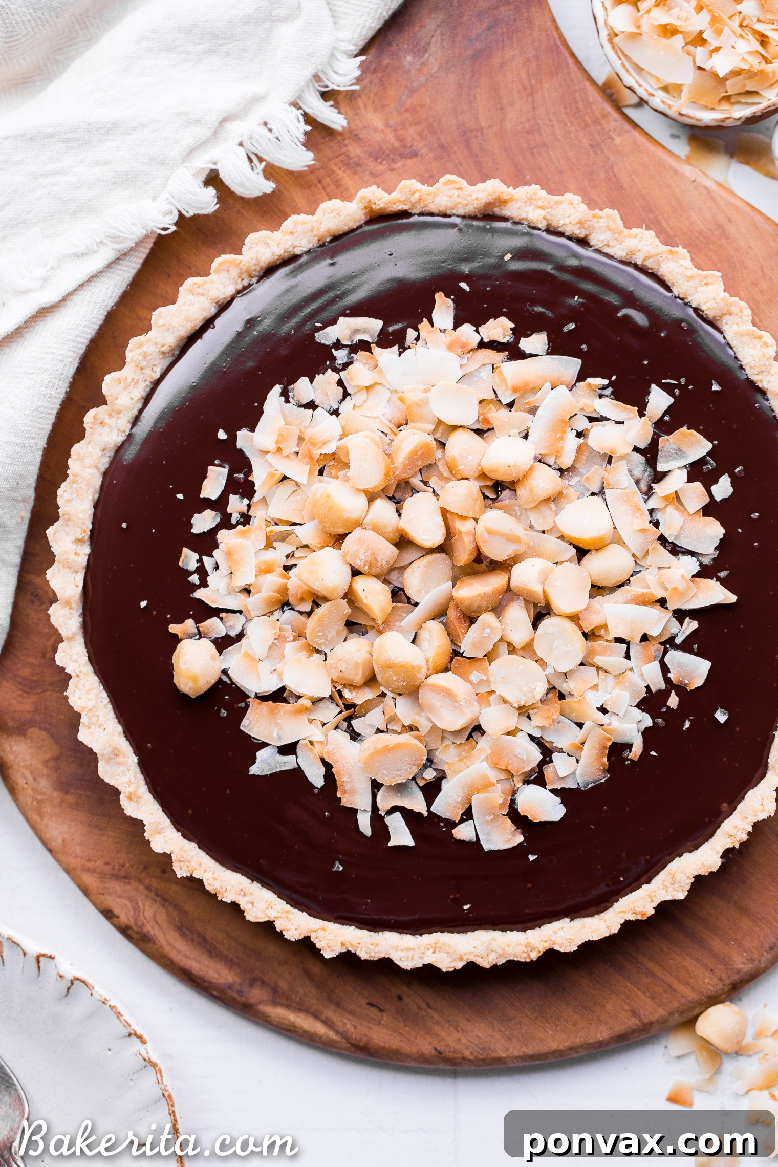 This Dark Chocolate, Coconut & Macadamia Nut Tart is decadent, delicious and easy to make. It has a coconut crust that's filled with a luscious chocolate ganache and topped with toasted coconut and macadamia nuts. You'd never guess that this nutty tart is gluten-free, vegan, Paleo, and refined sugar-free!