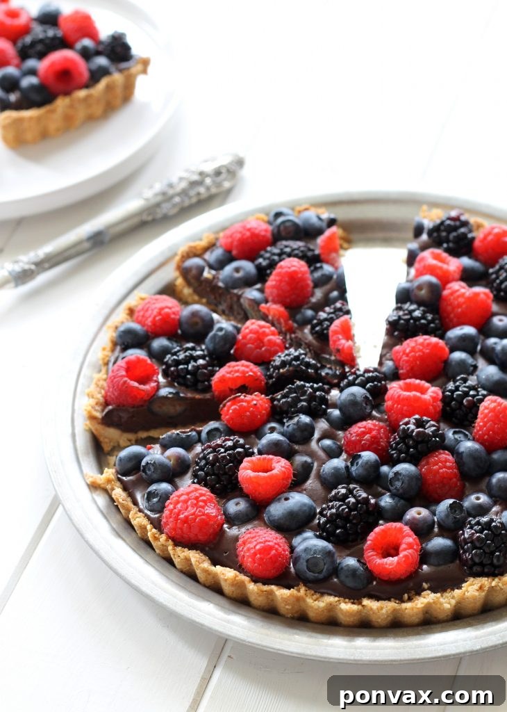 This Chocolate Berry Tart has vegan chocolate ganache in an almond flour crust, topped with berries! It is Paleo, gluten-free, vegan and refined sugar-free.