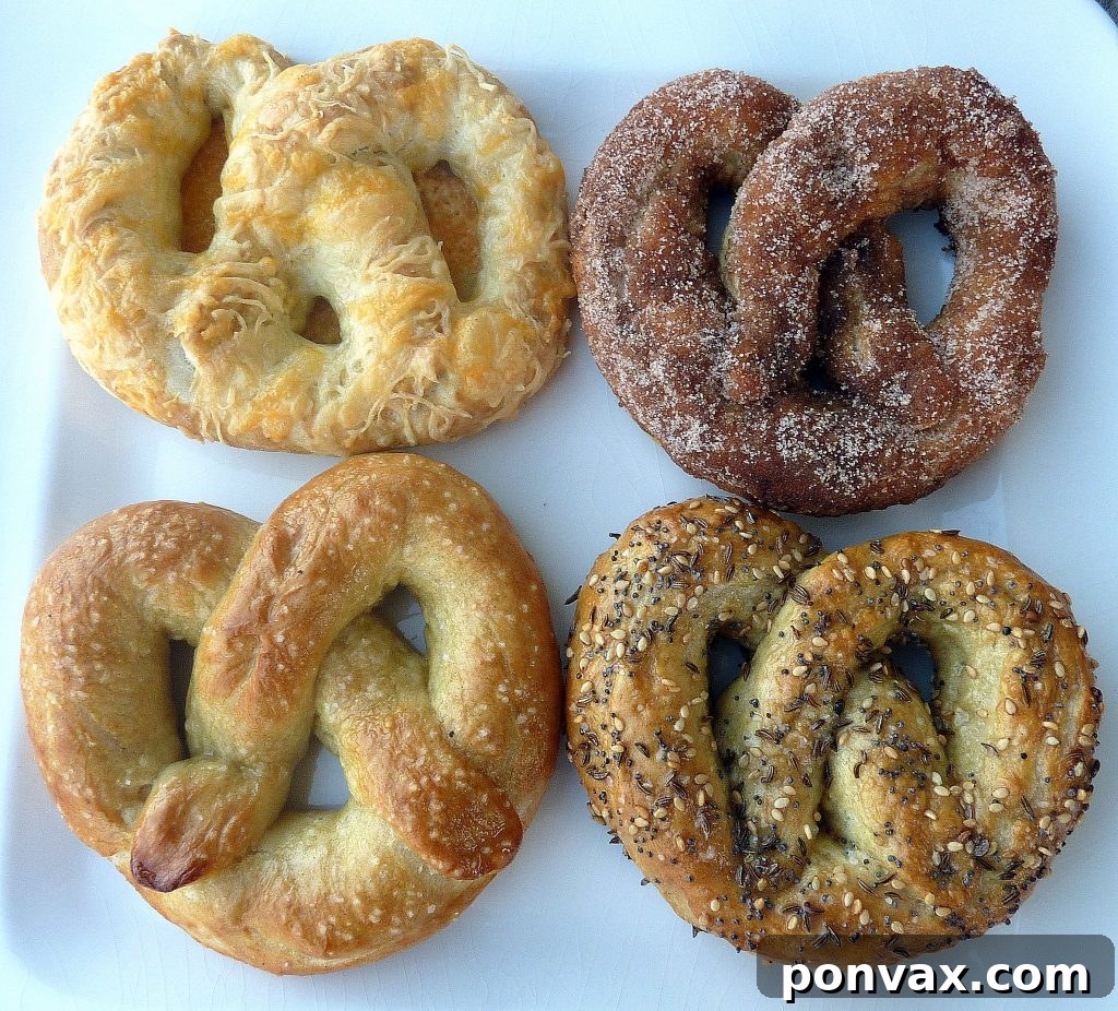 Homemade Soft Pretzels with four distinct toppings: classic salted, savory cheesy, everything bagel seasoning, and sweet cinnamon sugar coating.
