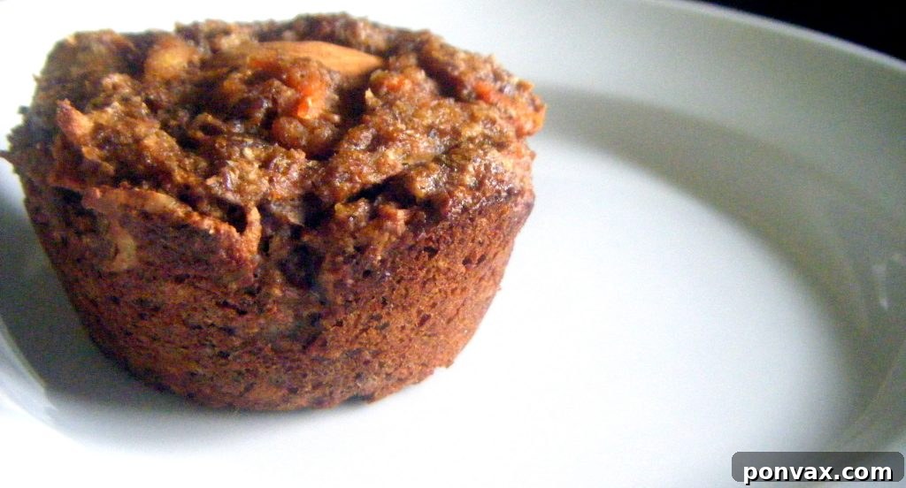 Delicious Whole Wheat Apple Carrot Muffins Close-up of freshly baked Whole Wheat Apple Carrot Muffins, showcasing their wholesome texture and ingredients.