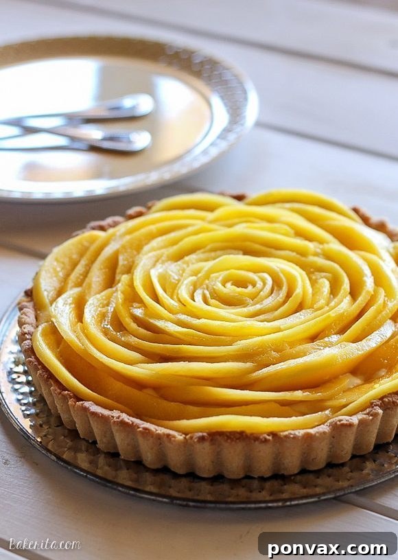 This Mango Tart uses fresh, ripe mangos and coconut cream to make a delicious dessert that's gluten-free, Paleo friendly, refined sugar-free, and vegan! The recipe includes step by step photos for how to make a beautiful mango flower.