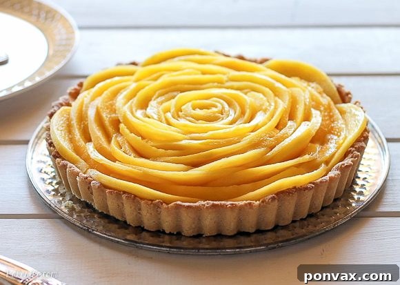 This Mango Tart uses fresh, ripe mangos and coconut cream to make a delicious dessert that's gluten-free, Paleo friendly, refined sugar-free, and vegan! The recipe includes step by step photos for how to make a beautiful mango flower.