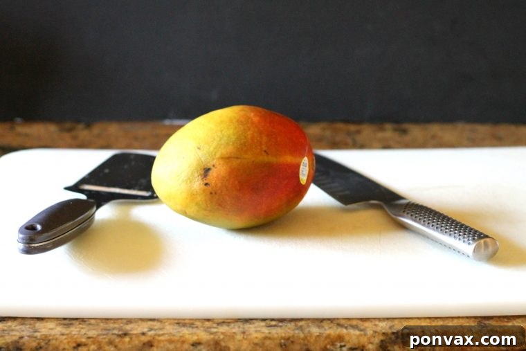 Step-by-step image of how to peel a mango for a tart