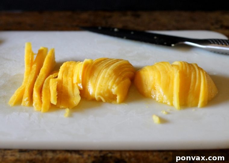 Step-by-step image of perfectly sliced mango pieces for a tart