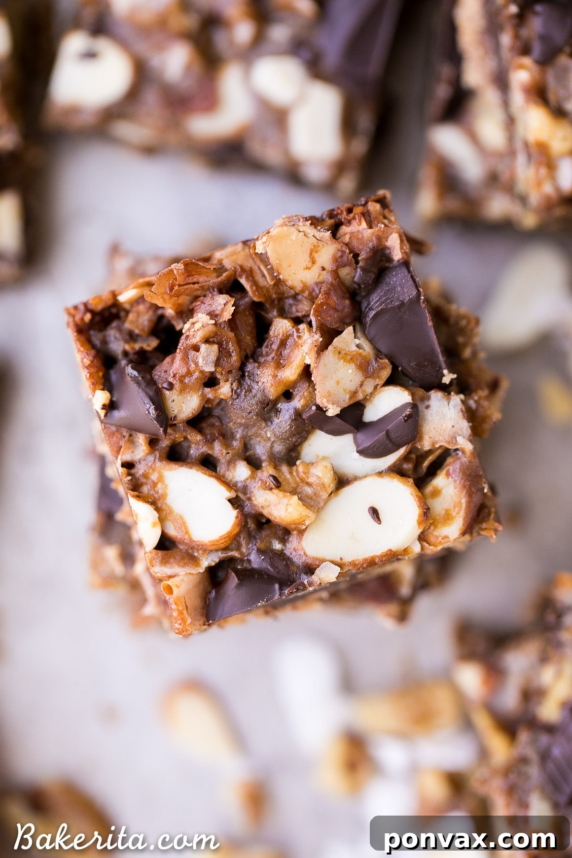 Gluten Free Vegan Paleo Magic Cookie Bars 5 Hand holding a piece of Paleo Magic Cookie Bar, showing its rich texture