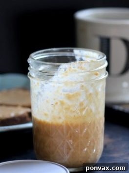 A jar of smooth homemade Toasted Coconut Butter.