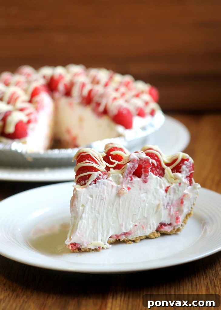 Indulge in this quick and easy no-bake raspberry white chocolate cheesecake pie, perfect for summer gatherings. A simple 6-ingredient recipe, ready in 15 minutes, with a stunning presentation.