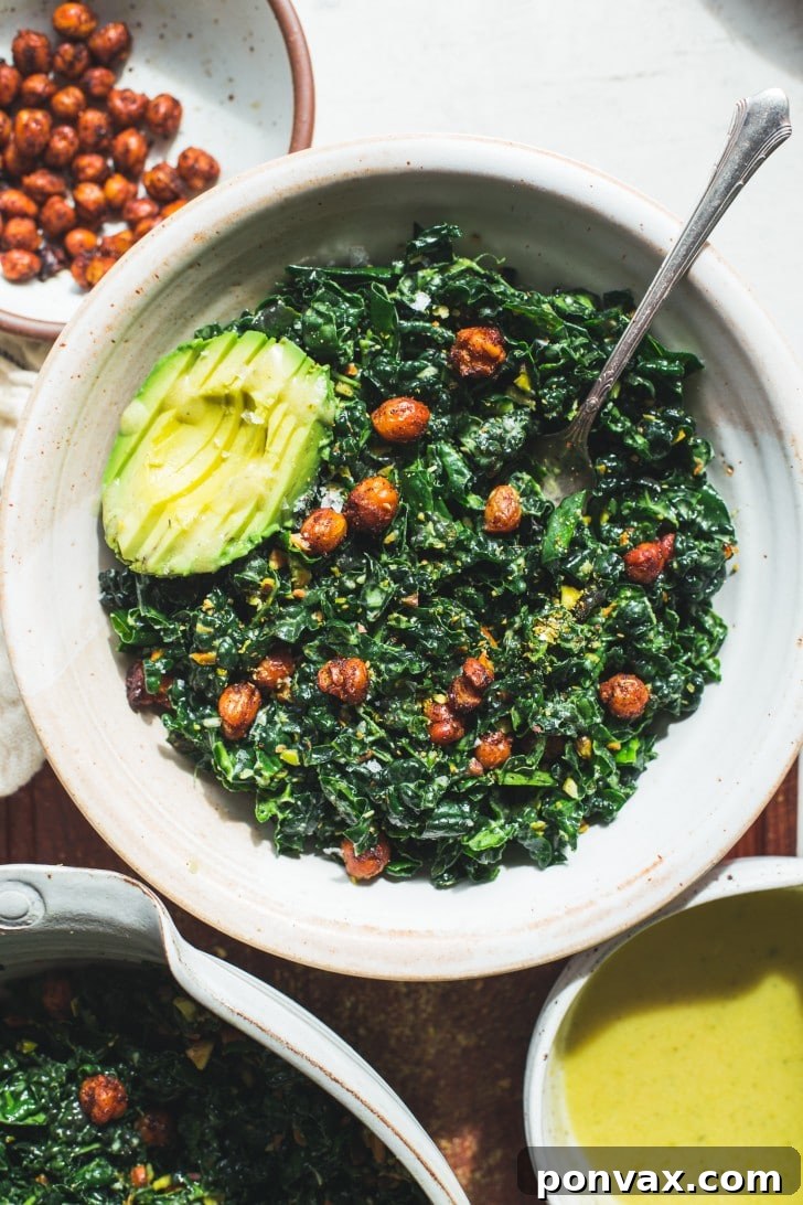 A large bowl of fresh massaged kale chickpea salad with lemon vinaigrette