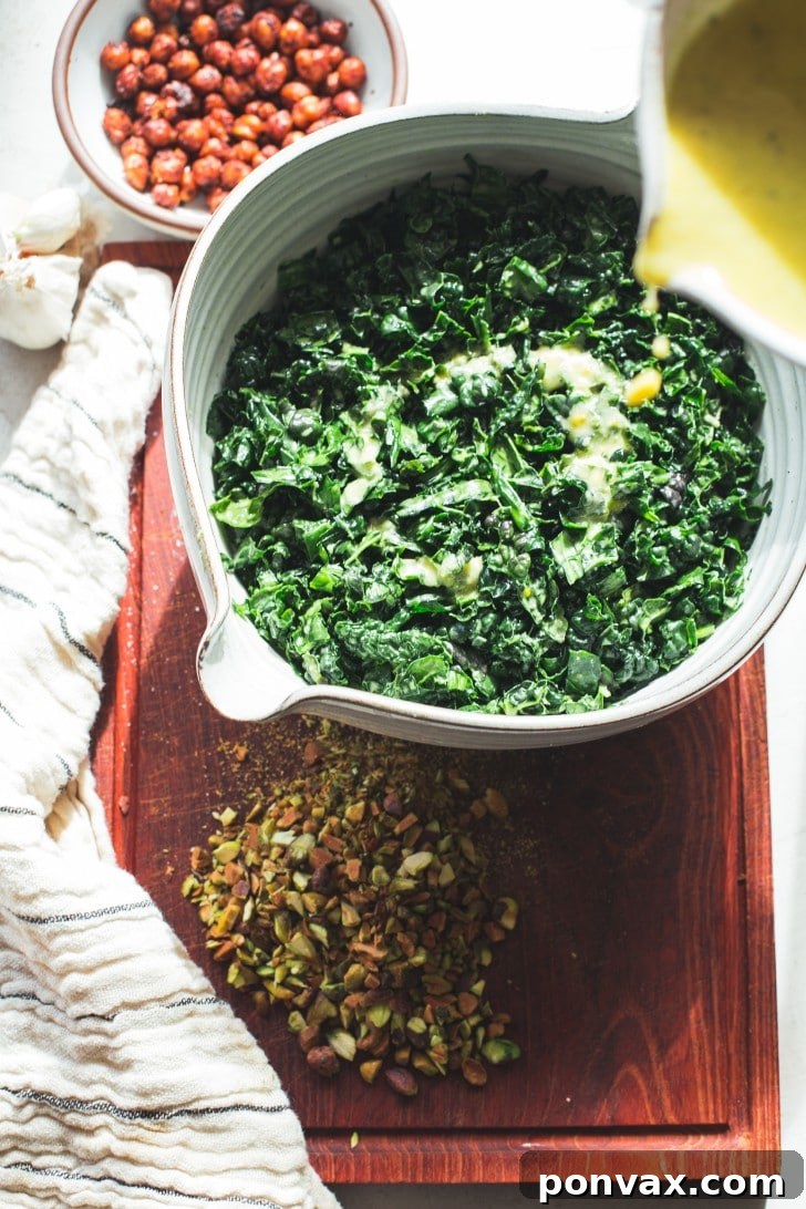 Ingredients for lemon vinaigrette on a white surface: lemons, garlic, olive oil, tahini, and spices